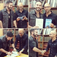 Mark Zolo and Neil Strauss exchanging their latest books